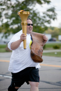 Centerville, IN, Retail Associate Jeff Fudge carries a torch and his uncle’s saddlebag as part of the Indiana Bicentennial Torch Relay. 