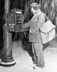 Mail carrier using delivery zone numbers during World War II, circa 1950